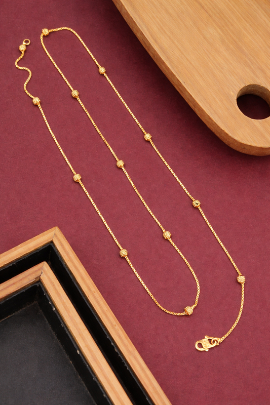 Sivorae 24 inch brass micro polish golden chain necklace with textured gold beads and lobster clasp on burgundy background