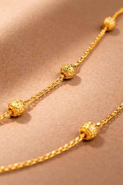 Detailed close-up of Sivorae 24 inch golden brass chain necklace highlighting intricate textured bead design and high-polish premium finish