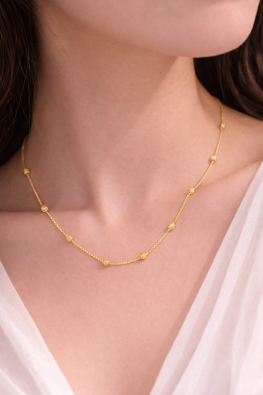 Woman wearing Sivorae 24 inch golden beaded brass chain necklace with micro polish finish and adjustable clasp