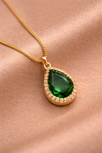 Close-up of Sivorae green teardrop gemstone pendant necklace with gold finish and cubic zirconia halo