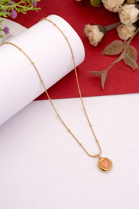 Sivorae steel golden heart pendant necklace with peach stone on elegant background for women